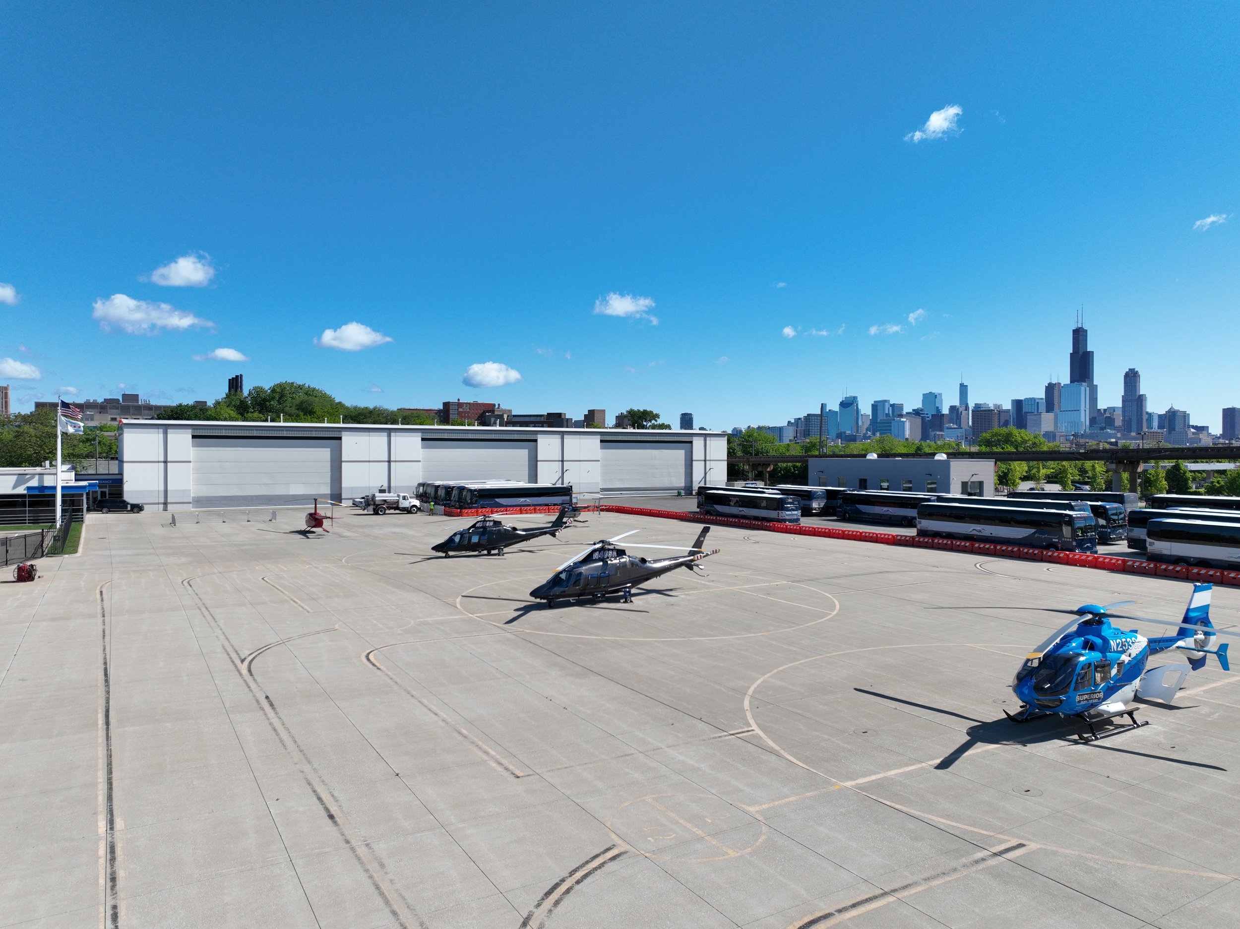 Aerial view of the Vertiport Chicago pad with helicopters and the skyline